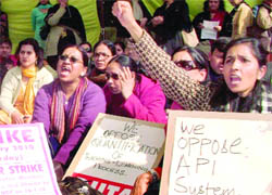 Members of the Federation of Central Universities Teachers Association stage a dharna at the UGC office to press for their demands related to pay revision, better service and working conditions, in New Delhi on Saturday.