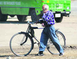 My bicycle may be outdated, but I am cell phone savvy, is what this man seems to convey. 