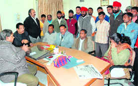 Senior Congress leader Suryakant Dhasmana, along with locals, at the DMC office in Dehradun on Saturday.