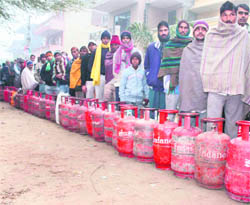 People queue up to get their LPG cylinders refilled in Gurgaon as the city faces scarcity of gas.