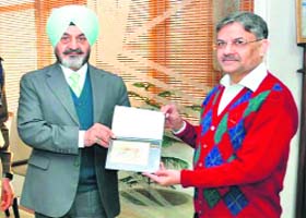 Punjab DGP Paramdeep Singh Gill (left) releases a table calendar themed Wildlife of Bandhavgarh and Kanha Forests, in Chandigarh