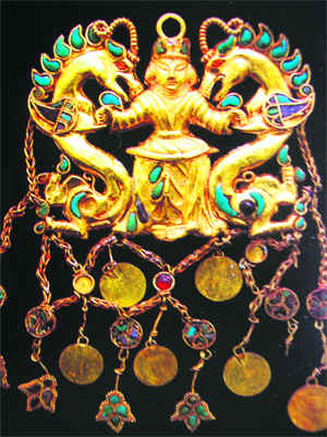 Pendant showing the Dragon Master; gold, turquoise and lapis lazuli. From tomb II, at Tillya Tepe; second quarter of 2nd century AD. National Museum of Afghanistan