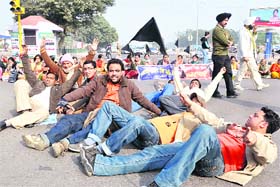 Computer teachers stage a dharna on the road separating Phases VII and VIII in Mohali