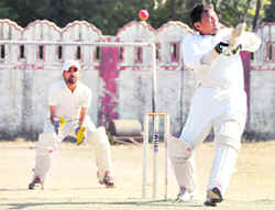 A player deals with a bouncer in a match of the 58th District Cricket League on Sunday.