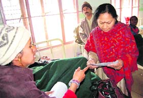 Snehlata Agarwal, Commissioner (Disability), Uttarakhand, talks to a disabled worker who is on a fast in Dehradun
