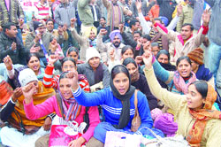 Members of the Paramedical Contract Mulazam Union stage a protest at Hall Gate in Amritsar.