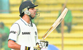 Yuvraj Singh looks at his bat after being dismissed on Sunday.