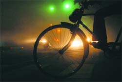 A cyclist waits for a chance to cross the busy road separating Sectors 9 and 10 in Chandigarh