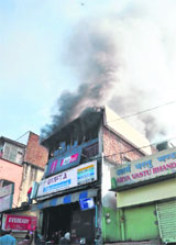 An electronics shop on fire at the Dispensary Road in Dehradun on Monday;