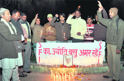 Members of the SFI light candles to pay tributes to Jyoti Basu in Dehradun on Monday. 