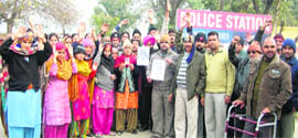 Residents of Aman Nagar stage a dharna against a retired cop in Ludhiana on Monday.