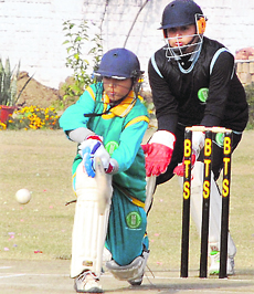 A batsman plays a shot during the first U-13 Tricity Premier League Cricket Tournament at Banyan Tree School Ground, Sector 48, on Tuesday.