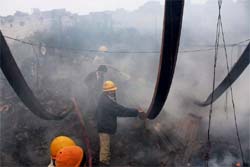 Firefighters douse fire that broke out in a cardboard manufacturing unit near Basai Village in Gurgaon 