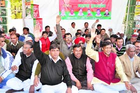 Samajwadi Party workers hold a protest against rising prices in Dehradun