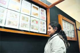 A visitor looks at the bank notes put up at an exhibition underway at Uttaranchal Grameen Bank Art Gallery in Dehradun