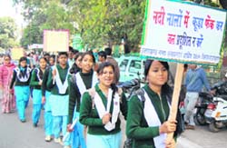 Schoolgirls participate in a rally to highlight the pollution in rivers in Dehradun 