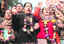 BJP activists hold a protest against price rise in Jammu on Tuesday.