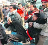 An injured PDD daily wager being taken to the GMCH in Jammu on Tuesday.