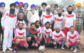 The winning team of the football show match pose with the guests of honour at Abbuwal village.