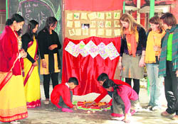   Students of Nanhi Duniya draw a rangoli on the occasion of Basant Panchami in Dehradun on Wednesday.