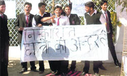   Students protest outside the ICFAI varsity campus in Dehradun on Tuesday. 