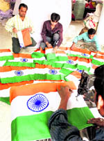Workers busy at a Tricolour workshop ahead of the 60th Republic Day in Ahmedabad on Wednesday