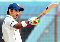 Gautam Gambhir raises his bat after completing a century on Wednesday