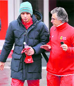 Moto GP world champion Italian Valentino Rossi (L) walks on the paddock during a test session on a Ferrari F2008 at Catalunyas racetrack near Barcelona, on Wednesday