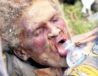 Earthquake victim Anna Zizi drinks water after being carried out alive from the rubble on Tuesday. 