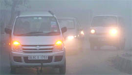 Drivers brave the morning fog in New Delhi on Thursday.