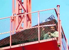 Puran Singh Rana, an ad hoc teacher, who is perched atop a Doordarshan tower, 