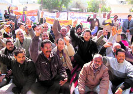 Members of the Hydro Electric Employees Union protest in Dehradun on Thursday