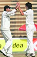 Yuvraj Singh (L) congratulates Ishant Sharma after he dismissed Raqibul Hasan