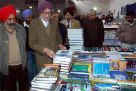 Jnanpith awardee Prof Gurdial Singh along with Vice-Chancellor of the Central University of Punjab Jai Rup Singh (extreme left) taking a round of the book exhibition on the university campus in Bathinda on Friday.