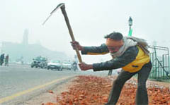 A labourer works on the Rajpath on Friday morning in New Delhi.