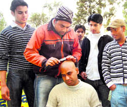 Eco Man Mahabir Singh Mehta, gets his head tonsured in protest against the degradation of environment in Dehradun on Friday