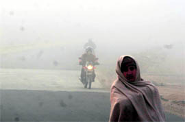 This motorcyclist has a tough time moving in poor visibility due to dense fog in Jammu