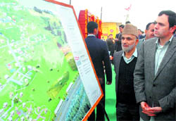CM Omar Abdullah has a close look at a project model of Swankha model village at Samba
