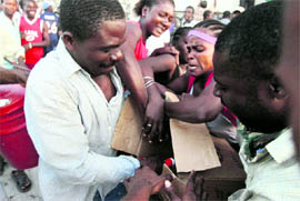 Haitians fight for food at a food distribution centre in Port-au-Prince on Thursday