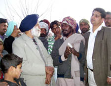 Member of the Punjab State SC Commission Dalip Singh Pandhi (left) along with Bathinda DC Rahul Tewari (extreme right) listening to Bhagwanpura residents on Saturday