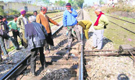 The damaged railway track being repaired near at Harrawala railway station in Dehradun on Saturday.