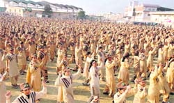 Volunteers of the Green S Welfare Force of Dera Sacha Sauda dance in unison on Friday evening in Sirsa