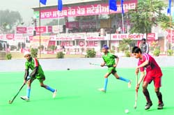 A hockey match in progress on the opening day of the 24th annual sports festival at Jarkhar village
