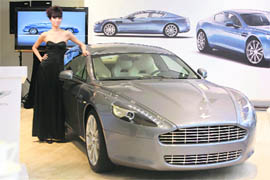 BIG AND BEAUTIFUL: A model poses with Aston Martins first production four-door sports car Rapide at the opening ceremony of its showroom in Beijing on Sunday.