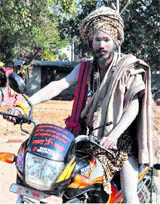 A Naga sadhu on his motor cycle reaches Haridwar to participate in the Maha Kumbh.