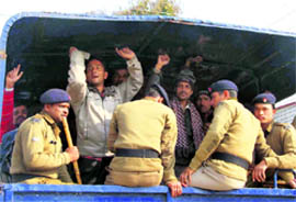 Agitating ad hoc teachers being taken to jail by the police in Dehradun on Sunday
