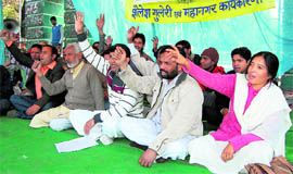 Workers of the Uttarakhand Kranti Dal hold a protest at the Gandhi Park in Dehradun on Sunday