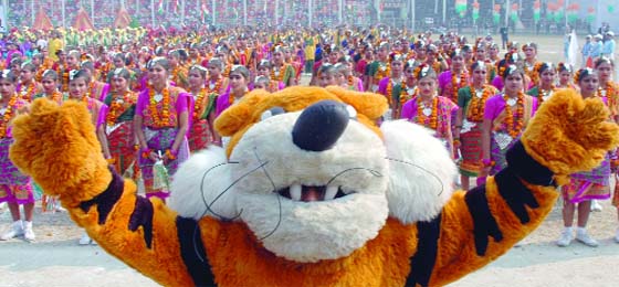 Schoolchildren present a programme during the Republic Day celebrations as Shera, the Commonwealth Games 2010 mascot, leads them at them Ambedkar Stadium in New Delhi
