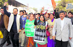 BJP workers take out a demonstration against rising prices in Dehradun on Monday