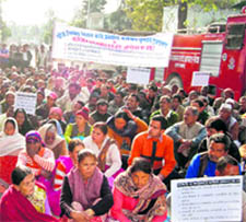 PWD workcharged employees hold a demonstration at the gate of the civil secretariat in Dehradun on Monday